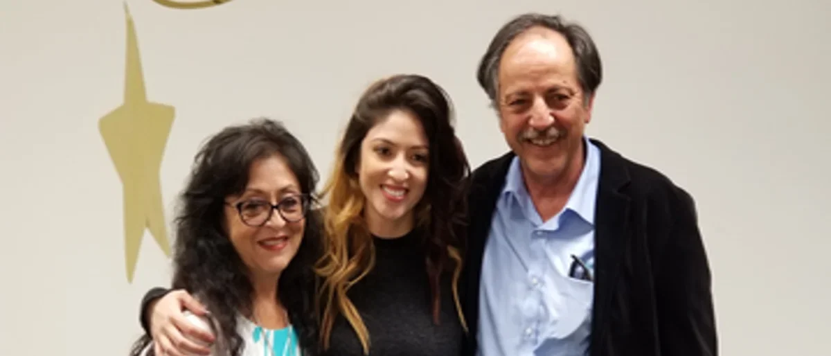 Erica Arroyo and parents smiling, celebrating PhD defense.
