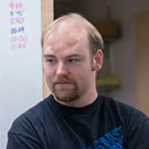 David Johnston in front of white board.