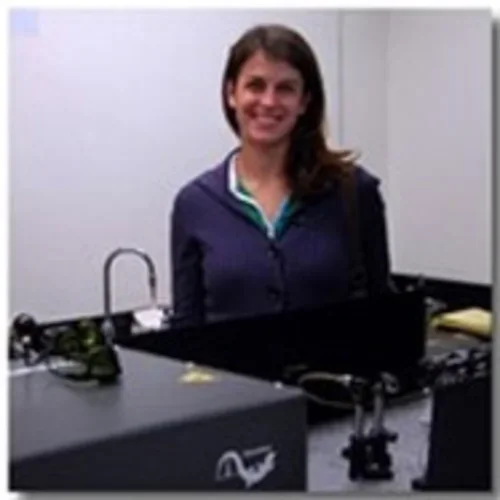 Georgeann Sack (formerly O'Brien) sitting at desk in lab.