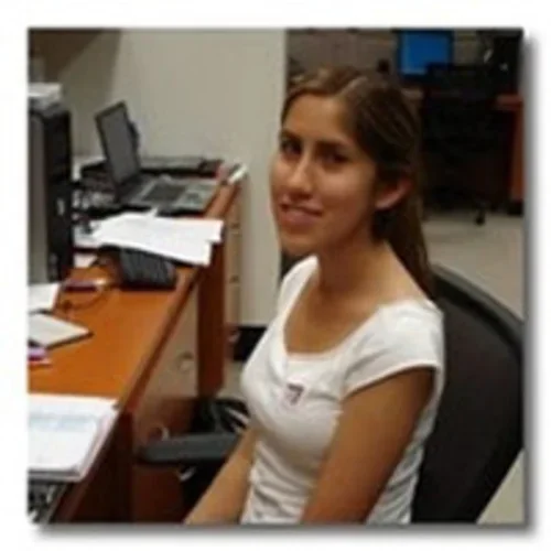 Michelle Crespo at desk.
