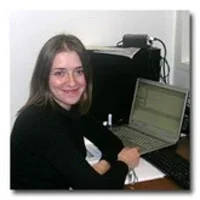 Natalia Orlova at desk with laptop.