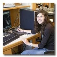 Seanna Martin at desk on computer.