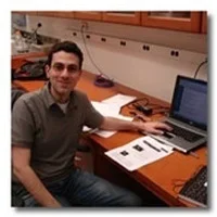 J. Tiago Goncalves at desk with computer.